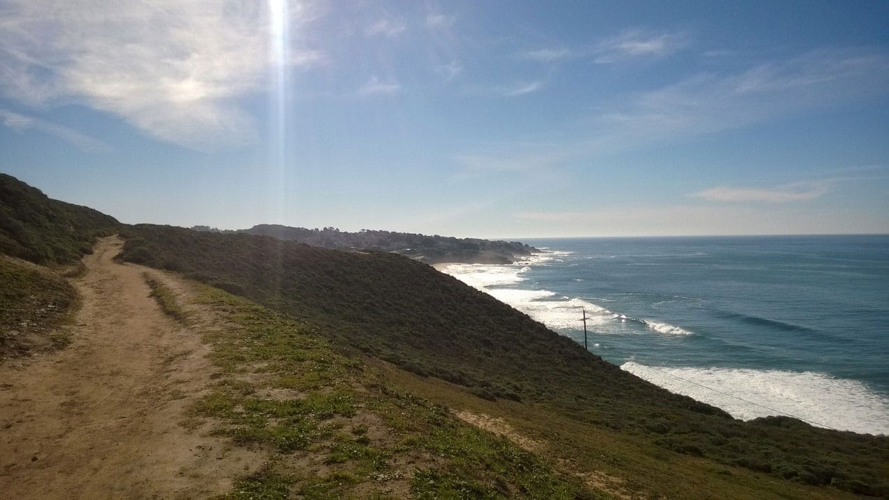 A mountain trail along the coast heading south.