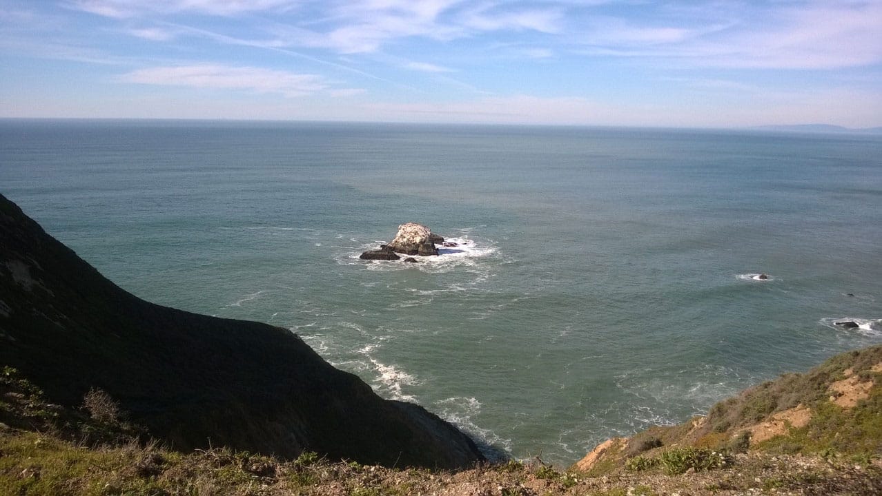 A photo of an island just off the shore.