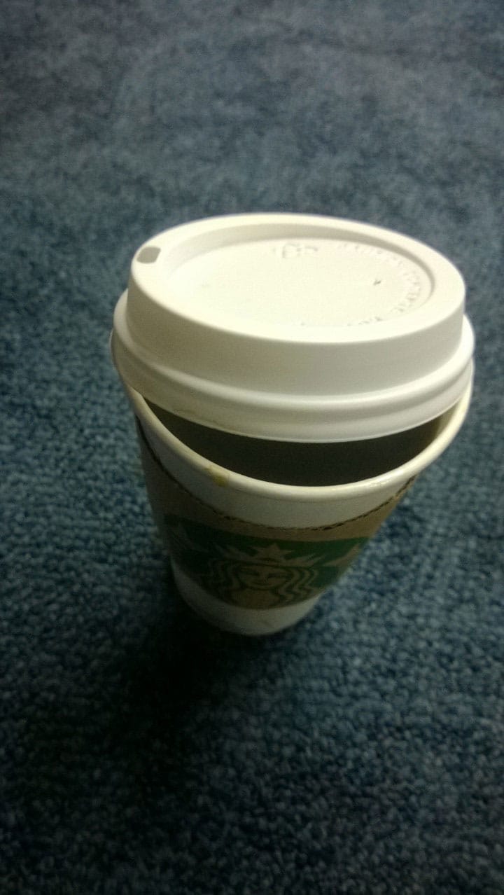 A photography of a Starbucks coffee cup from overhead.