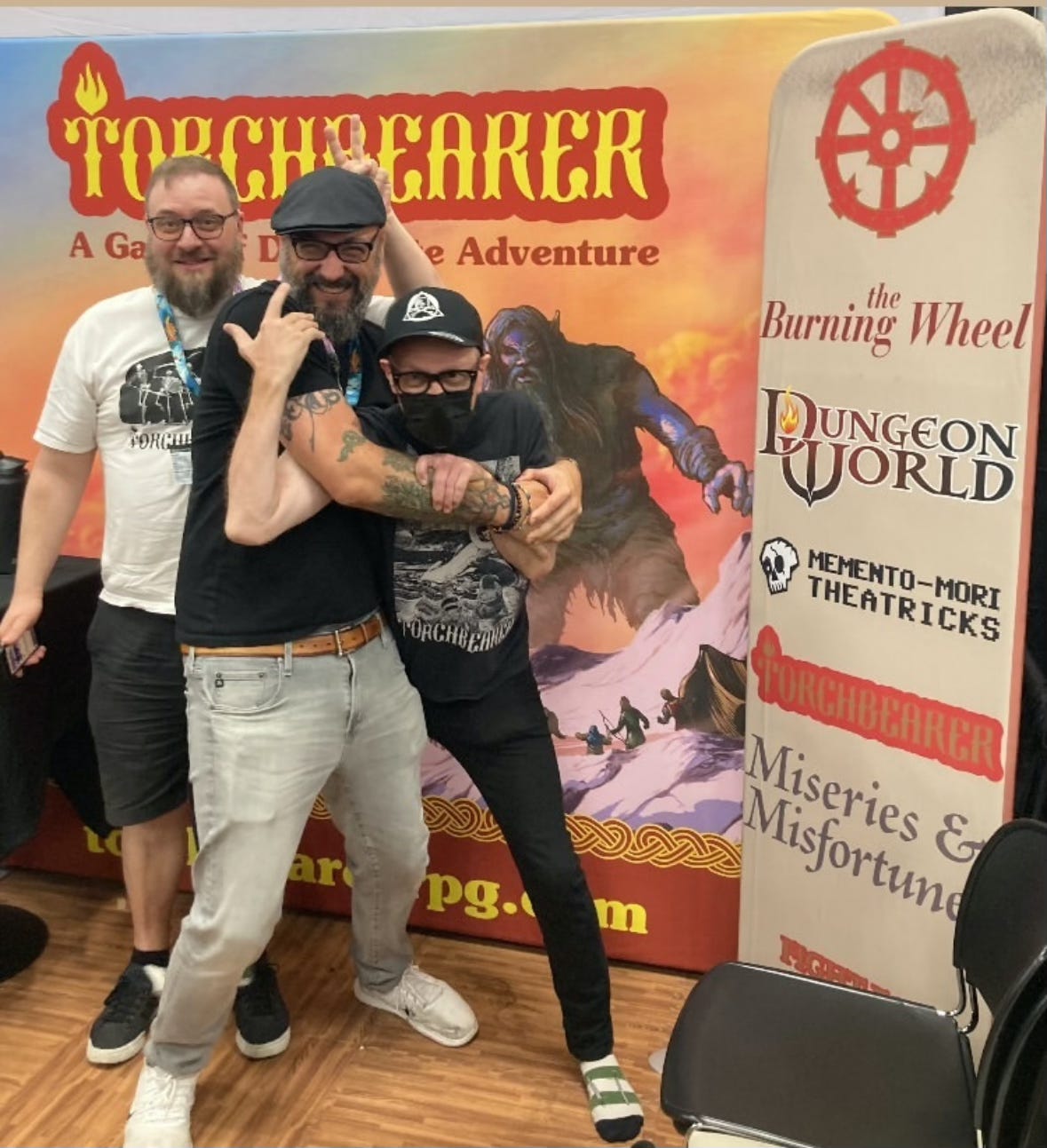 Thor, Keith, and Luke posing at the Burning Wheel booth at GenCon