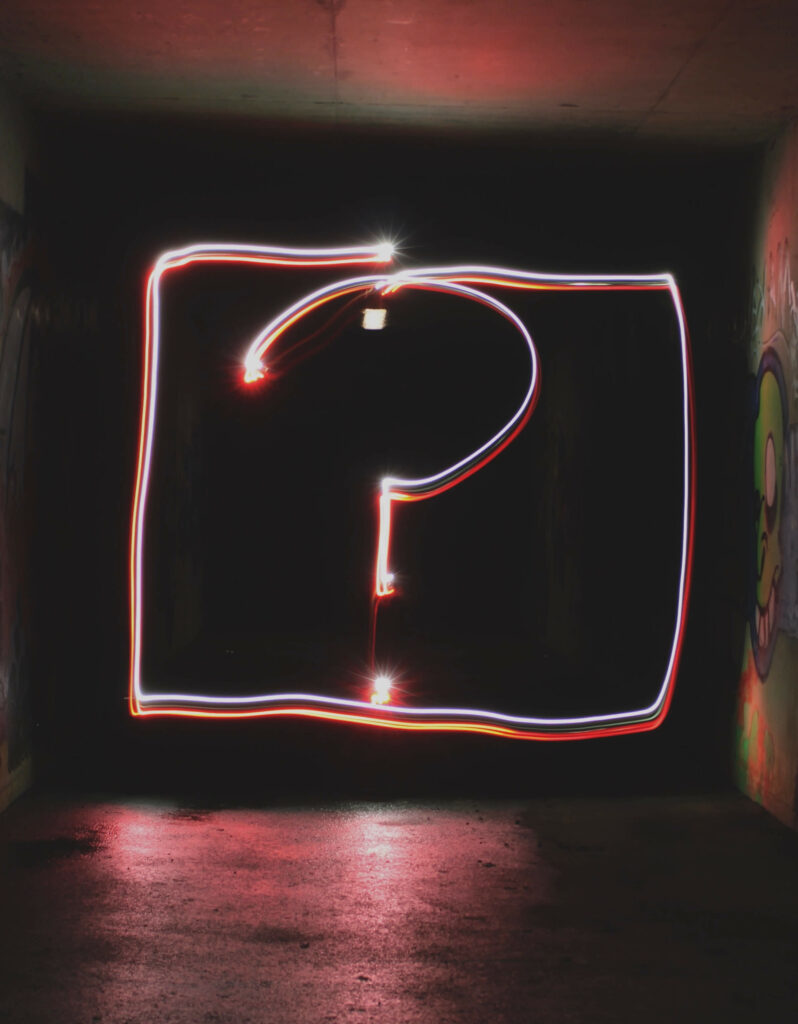 A question mark in neon